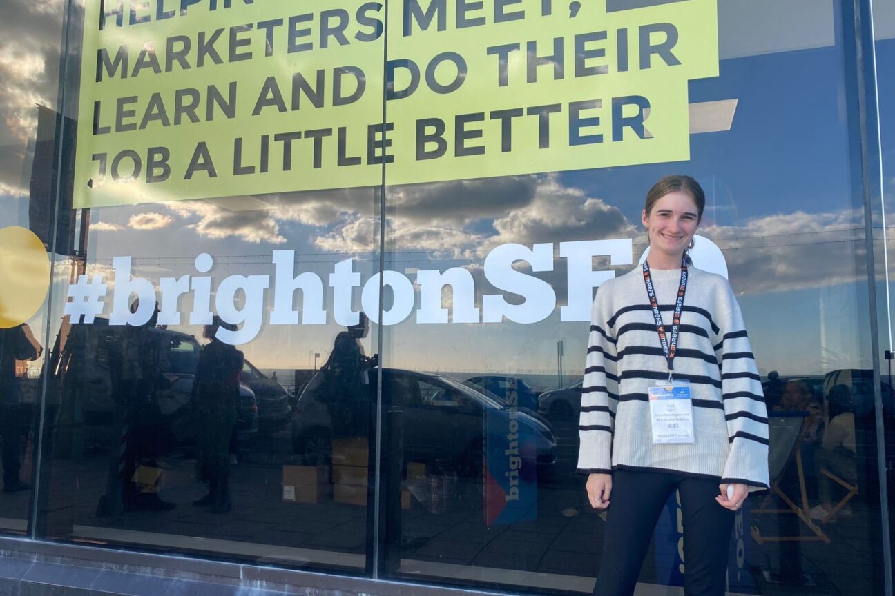 An image of Lucy standing in front of the Brighton SEO building