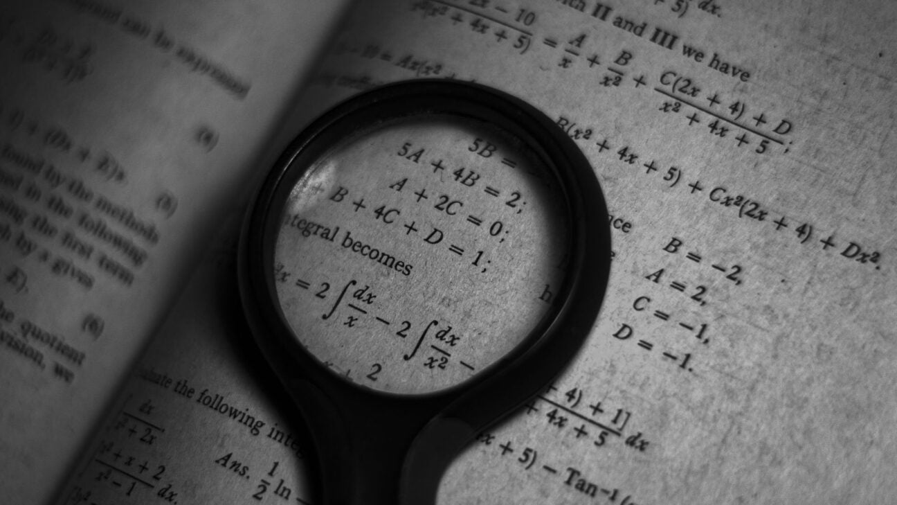 A magnifying glass hovering over formulae