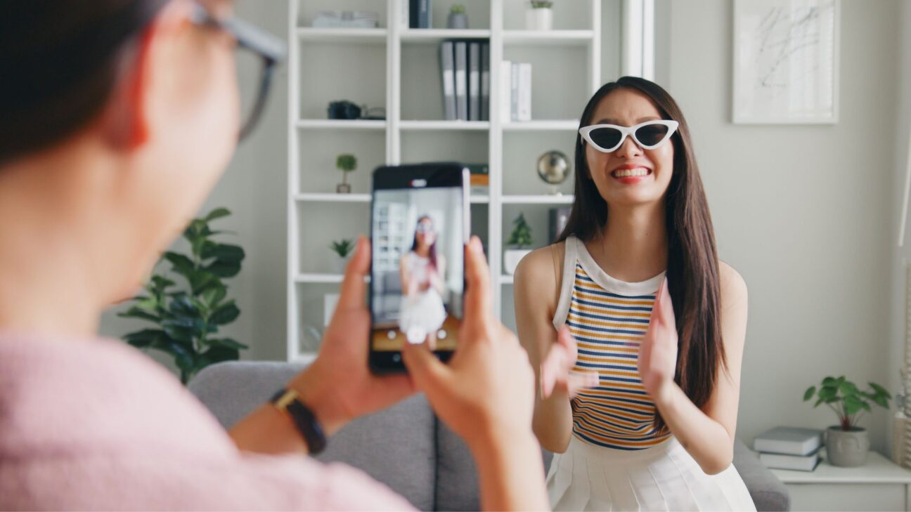 An influencer being filmed on a phone for TikTok.